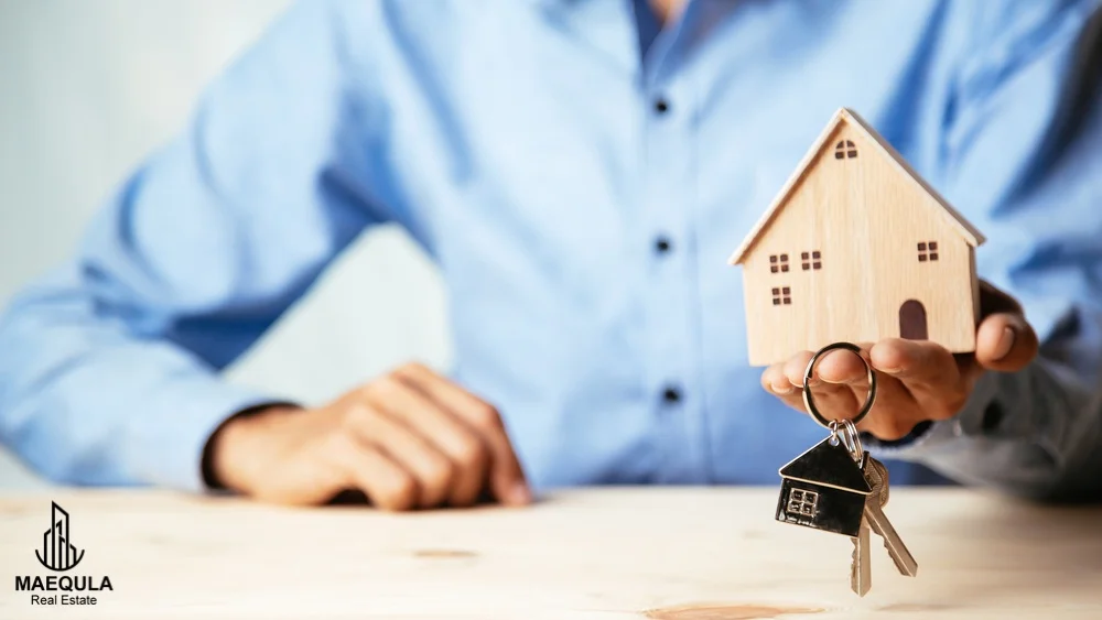 property dealer offering home model and keys tot he home